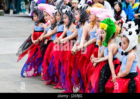 Japan, Kumamoto, Hinokuni Yosakoi Festival. Kinder Girl's Dance Team, verkleidet als Feen in Rot zogen die Kostüme mit tierischen Hüte. Tanz im Freien. Stockfoto