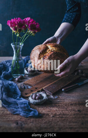 Frau einen frisch gebackenen süßen Osterbrot in ihren Händen hält Stockfoto