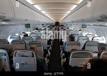 Gesamtansicht, Flugzeugkabine eines vollen Passagierflugzeuges (in diesem Fall ein BA Airbus A320-200). Stockfoto