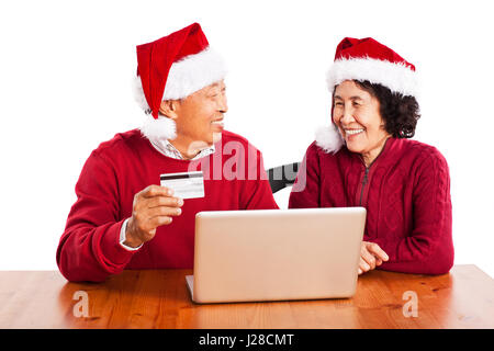 Ein Schuss von senior asiatischen paar Einkaufen online-Weihnachten zu feiern Stockfoto