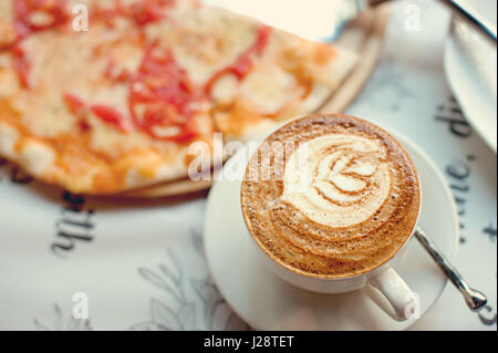 Kaffee und Pizza Margarita auf einer Papierserviette Stockfoto