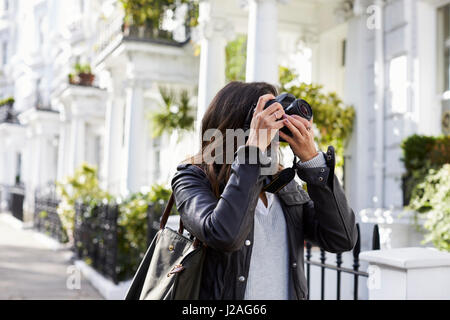 Junge Frau, die Aufnahme in eine Residenzstadt Straße Stockfoto