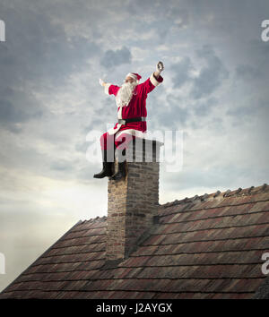 Santa Claus am Kamin sitzen Stockfoto