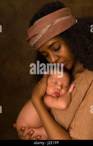 Äthiopische junge Mutter hält ihr 7 Tage alten Baby vor einem dunklen Hintergrund Stockfoto