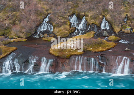 Hraunfossar, Reihe von Wasserfällen in den Fluss Hvítá im Winter Gießen Vesturland, Berggipfeln, West-Island Stockfoto