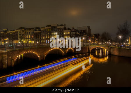 Leichte Spuren von einem vorbeifahrenden Boot auf den Kanälen von Amsterdam, Niederlande, an der Kreuzung der Keizersgracht und reguliersgracht Stockfoto