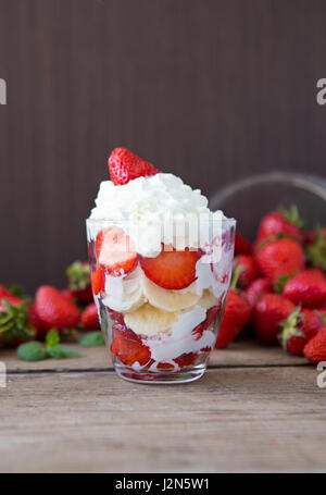 Frische Erdbeeren und Bananendessert mit Schlagsahne geschichtet Stockfoto