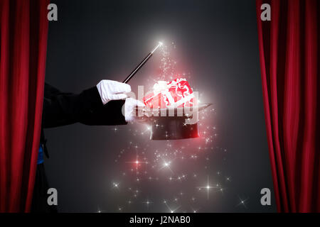 Zauberer-Hand mit Zauberstab machen Weihnachtsgeschenk, Weihnachten-Zauber Stockfoto