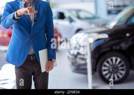 Auto-Agent im Auto Autohaus Saloon Taste Auto vor ihm Stockfoto