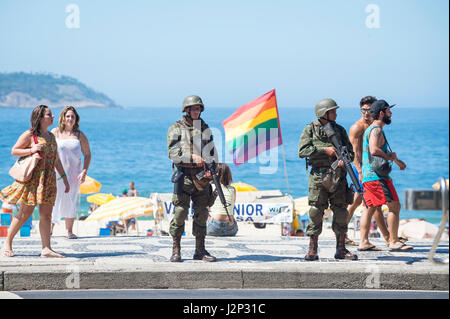 RIO DE JANEIRO - 15. Februar 2017: Zwei Soldaten in voller Tarnung Uniformen stehen mit Gewehren am Strand von Ipanema während eines Polizei-Streiks. Stockfoto