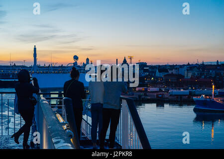 Unkenntlich Touristen fotografieren und genießen Helsinki Sonnenuntergang Stadtansicht von Cruise ferry Stockfoto