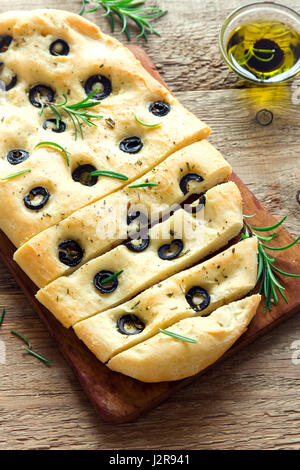 Traditionelle italienische Focaccia mit schwarzen Oliven und Rosmarin - Focaccia hausgemachtes Fladenbrot mit Olivenöl Stockfoto