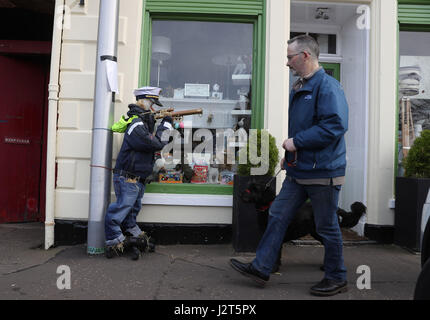 Ein Mann geht vorbei an einem Seemann Vogelscheuche auf dem Display während der Elie Scarecrow Festival in Elie, Schottland. Stockfoto