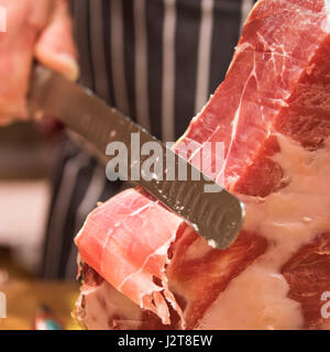 Platz in der Nähe bis von einem Metzger schneiden eine Serrano Ham. Stockfoto