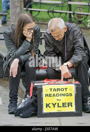 Psychische Kyler James eine Tarotkarte lesen zu einer jungen Dame im Washington Square Park in Greenwich Village, Manhattan, New York City geben. Stockfoto