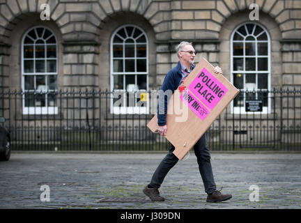 Polling-Logistik-Offizier Roy Drury trägt ein Wahllokal Zeichen von Lothian Chambers in Edinburgh, wie Wahl Personal aus Edinburgh Stadtrat Vorbereitungen im Vorfeld der Kommunalverwaltung Wahl machen. Stockfoto