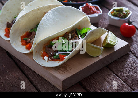 Beef Fajitas mit bunten Paprika in die Pfanne und Tortilla Brot und Soßen Stockfoto