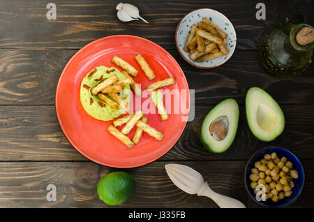 Avocado Hummus mit Mini Grissini, rustikale Stillleben Stockfoto