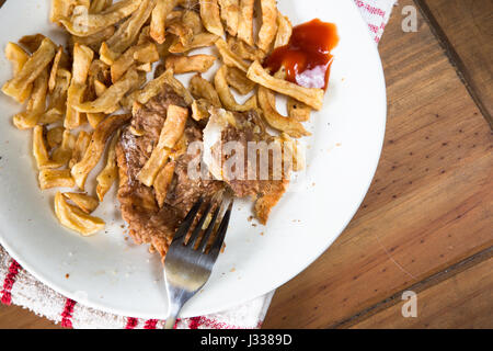 Übrig gebliebene Platte des englischen Fish and Chips essen. Stockfoto