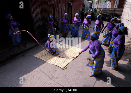 Frauen mit ihren verdeckten Gesichtern mit einem natürlichen weißen Maske namens musiro mussiro oder n iro Tanzen traditioneller Tanz im Barrio da Mafallala eine schlechte Slum von Maputo, der Hauptstadt von Mosambik, Afrika Stockfoto