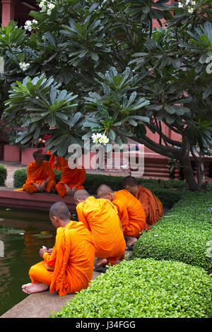 Buddhistische Mönche sitzen im Garten im Innenhof des Landesmuseums, Phnom Penh, Kambodscha Stockfoto