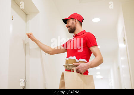 Lieferung Mann mit Kaffee und Essen vor Tür Stockfoto