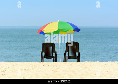 Zwei am Strand liegen und ein Sonnenschirm auf Marari Beach, Mararikulam, Distrikt Alappuzha (Alleppey), Kerala, Süd-Indien, Südasien Stockfoto