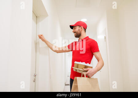 Lieferung Mann mit Kaffee und Essen vor Tür Stockfoto