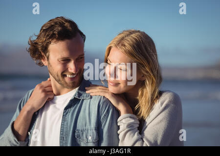 Junges Paar am Strand stehen an sonnigen Tag Stockfoto