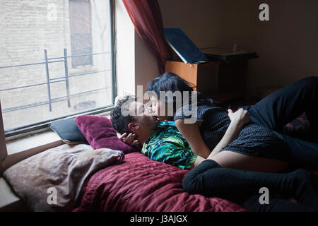 Junges Paar zusammen im Bett liegend Stockfoto