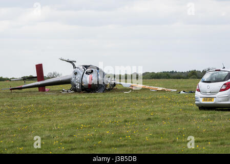 Booker, Buckinghamshire, England. 5. Mai 2017. 3 Männer, 2 sind ernsthaft verletzt worden, als der Hubschrauber, die, den Sie flogen am Wycombe Air Park (auch bekannt als Booker Airfield) Notdienste aus Buckinghamshire Feuer und Rettungsdienst, Thames Valley Police und South Central Rettungsdienst, die erste Szene stürzte, eilte zu der Absturzstelle bei ca. 09:30BST waren. Ein Luft-Krankenwagen nahmen ebenfalls Teil. Im Bild: Die beschädigten Hubschraubers legt auf seiner Seite. Bildnachweis: Peter Manning/Alamy Live-Nachrichten Stockfoto