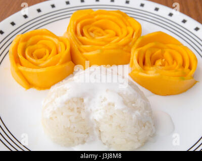 Mango mit Klebreis mit Kokosmilch auf Holztisch, Thai Dessert süß mischen Stockfoto