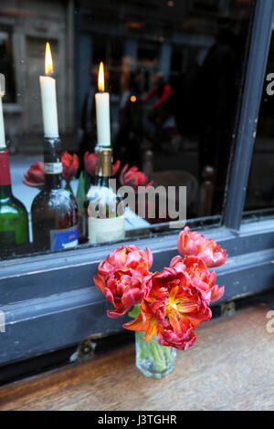 Kerzen in Flaschen Wein und Blumen am Tisch im Restaurant Andrew Edmunds in Lexington Street, Soho, London KATHY DEWITT Stockfoto