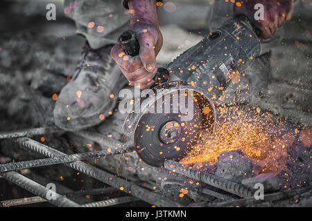 Bauarbeiter schneidet hohle Stahl Vierkantrohr mit Kreissäge Stockfoto