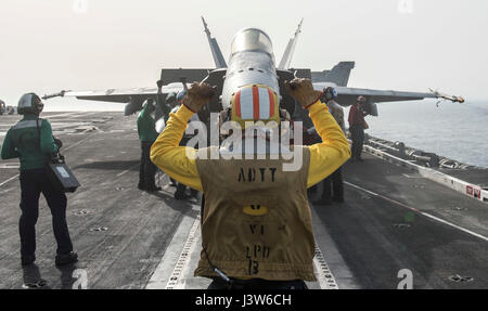 170429-N-FE442-062 arabischen Golf (29. April 2017) Luftfahrt Boatswain Mate (Handling) 1. Klasse Eric Ballard signalisiert ein Flugzeug an Bord des Flugzeugträgers USS George H.W. Bush (CVN-77) (GHWB). GHWB in den USA bereitgestellt wird 5. Flotte Bereich der Maßnahmen zur Erhöhung der Sicherheit im Seeverkehr Operationen, Verbündete und Partner zu beruhigen, und die Freiheit der Schifffahrt und den freien Fluss des Handels in der Region zu erhalten. (Foto: U.S. Navy Mass Communication Specialist 3. Klasse Matt Matlage/freigegeben) Stockfoto