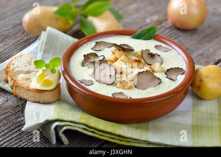 Creme von Kartoffelsuppe mit köstlichen geschnittenen schwarzen Herbst Trüffel, serviert mit geröstetem Ciabatta-Brot mit butter Stockfoto