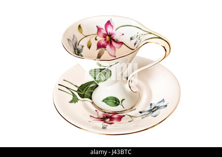 Vintage Teetasse und Untertasse mit Blättern und zarten Blüten auf isolierte Hintergrund Stockfoto