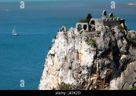 Die Reste der alten Burg von Duino bei Triest. Die ersten befestigte Kern des Schlosses Duino erhebt sich im 11. Jahrhundert auf einem Felsvorsprung über dem Meer und vor dem neuen Schloss. Ruinen sind durch einen Weg und eine Zugbrücke erreichbar. Die alte Dame Schloss knüpft an die Legende der weißen Frau. Stockfoto