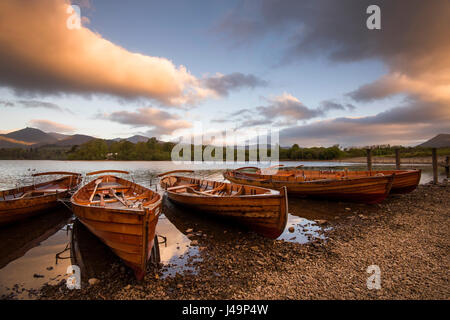 Ruderboote bei Sonnenaufgang auf Derwentwater im Lake District, Cumbria, England UK Stockfoto