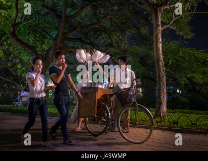 HANOI, VIETNAM - ca. SEPTEMBER 2014: Passanten am Hoan-Kiem-See in der Nacht in Hanoi, Vietnam. Stockfoto