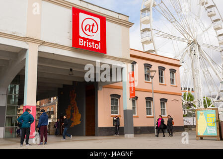 Eingang des At-Bristol (@Bristol) Science Museum mit Besuchern und Touristen, die herumlaufen und Riesenrad im Hintergrund, am Hafen, Bristol Stockfoto