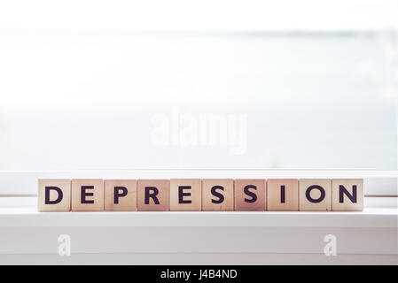 Depression Wort Om hölzerne Würfel in einem hellen Raum Stockfoto