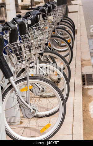 City-Bikes zu vermieten. Reihe von Fahrradverleih vor der Straße geparkt. Stockfoto