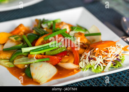 Gemüse mit Garnelen auf einem Teller in süß-saurer Sauce Nahaufnahme Stockfoto