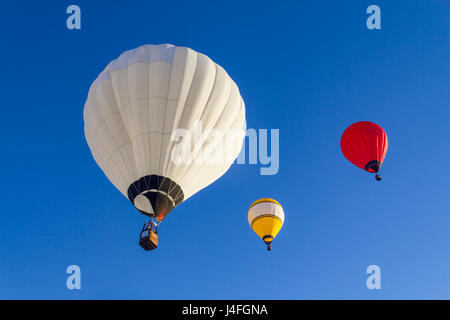 Gruppe von bunten Heißluftballons fliegen in einen blauen Himmel Stockfoto