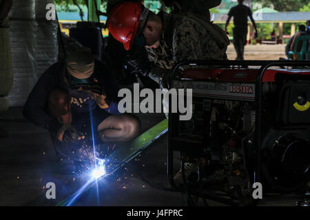 CAGAYAN, Philippinen-ein US-Marine-Ingenieur mit Bravo Company 9. Ingenieur Support Battalion, 3d Marine Logistics Group, III. Marine Expeditionary Force, eine philippinische Marine Generator Schweißen zur Wiederherstellung ein Abschnitts der San Vicente Elementary School während technische politische Unterstützung für philippinische amphibische Landung Übung 33 (PHIBLEX) 28. September 2016. PHIBLEX ist eine jährliche bilaterale Übung mit der Streitkräfte der Philippinen geführt. Die Übung kombiniert amphibischen Fähigkeiten und Leben-Heißausbildung mit bürgerlichen humanitärer Anstrengungen zur Stärkung der Interoperabilität eine Stockfoto