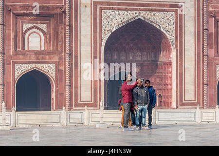 Touristen fotografieren nur außerhalb der wichtigsten Grab Eingang des Taj Mahal in Agra, Indien gelegen. Stockfoto