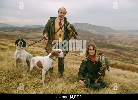 Falkner Steve und Emma Ford posiert mit den Falken Jagd und Hunde auf die Mauren in Gleneagles, Schottland. Derek Hudson/Alamy Stock Foto Stockfoto