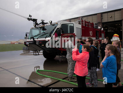 Edison-Grundschule Wissenschaft, Technik und Mathematik Mädchen beobachten einen Flugplatz Feuerwehr Rettungswagen Wasser auf der Minot Air Force Base, N.D., 1. Mai 2017 Spritzen. Die Stamm-Mädchen hatte die Gelegenheit, Wasser von einem ARFF Fahrzeug auf ein Praxis-Ziel während ihrer 5. Civil Engineer Squadron Feuerwache Tour zu spritzen. (U.S. Air Force Photo/Flieger 1. Klasse Alyssa M. Akers) Stockfoto