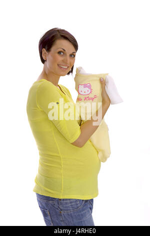 Schwangere Frau in glücklich Erwartung zeigt Baby-Bekleidung, Modell veröffentlicht, keine Property-Release, Stockfoto